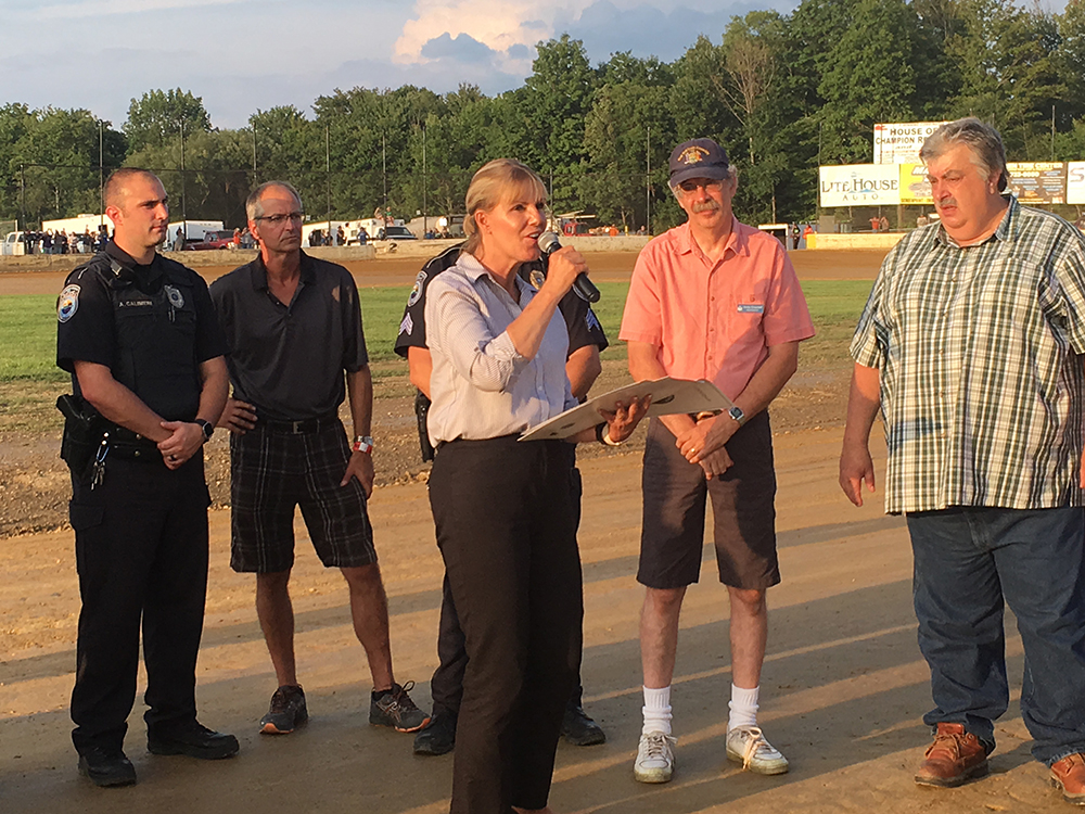 New York State Senator Katherine Young reads a proclamation welcoming Stateline Speedway to New York State and Chautauqua County as county and Town of Busti officials look on.